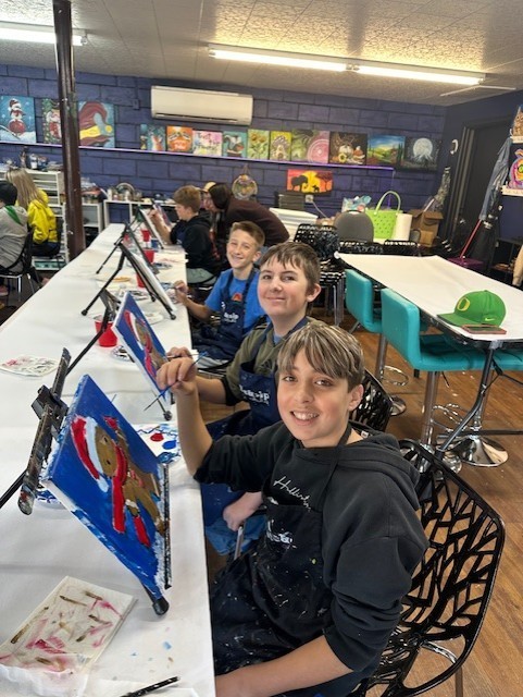 Nick Tillet and other leadership students enjoying the holiday paint event.