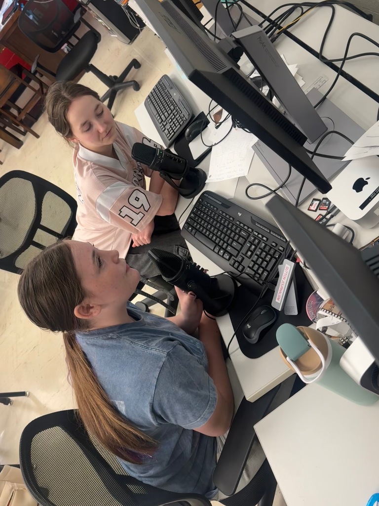 Photo of Nora Cox and Neomi Craig recording their podcast in class.