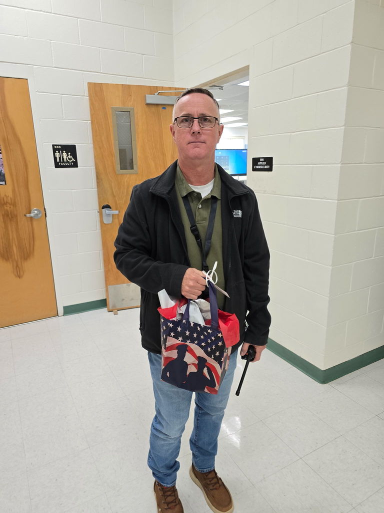 instructor posing with gift bag