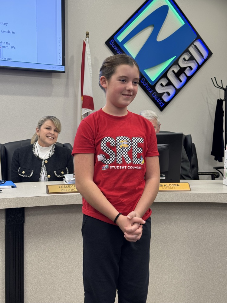 student presenting in front of board members - 1