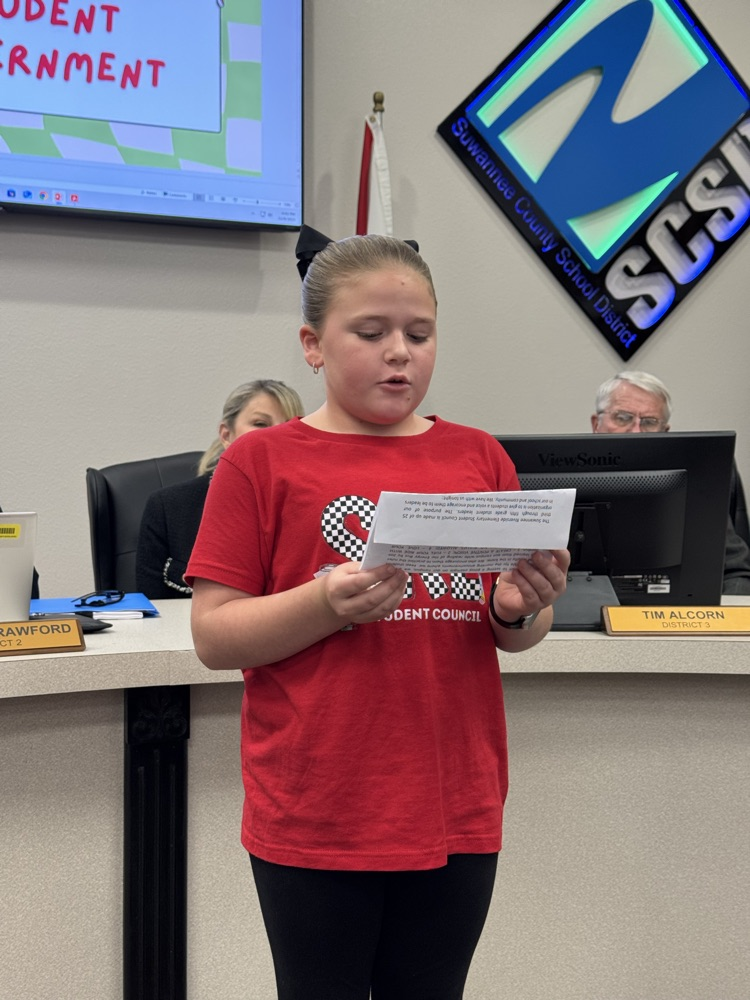 student presenting in front of board members - 2