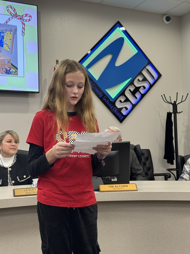 student presenting in front of board members - 3