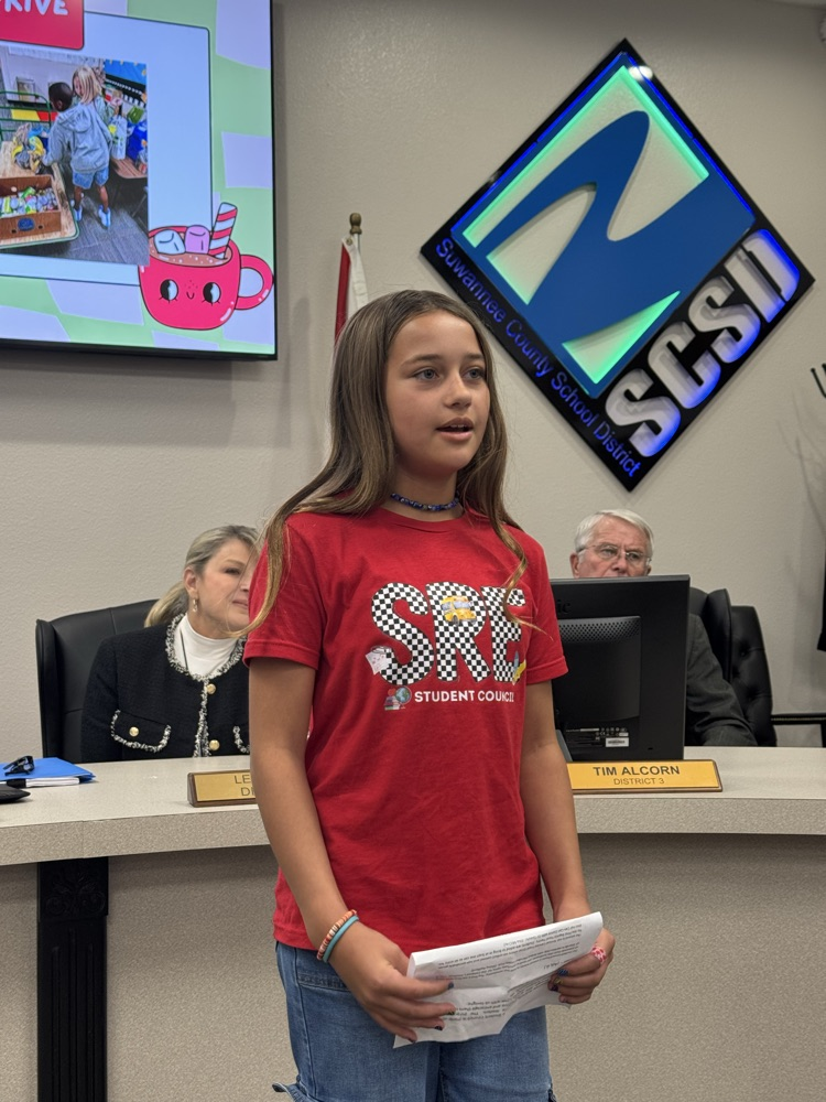 student presenting in front of board members - 4