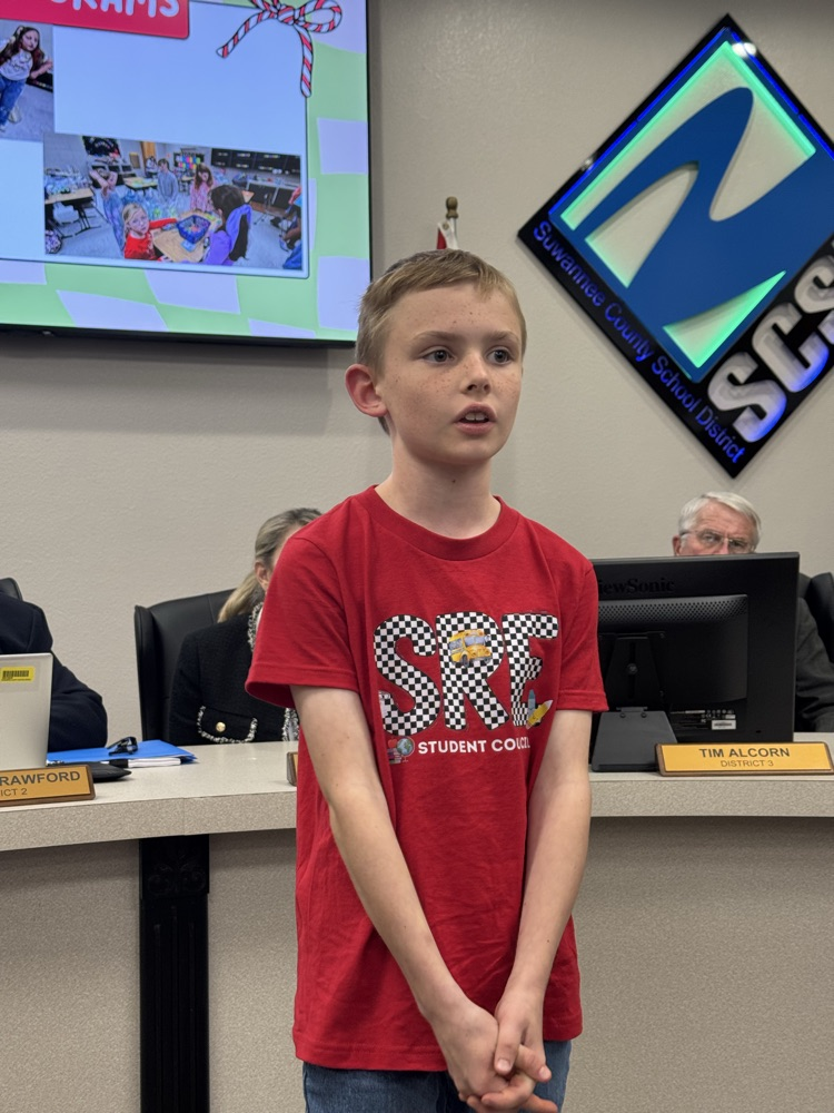 student presenting in front of board members - 5