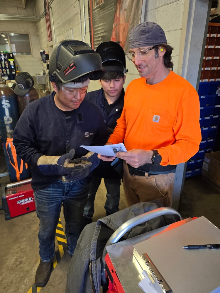 welders looking at paperwork
