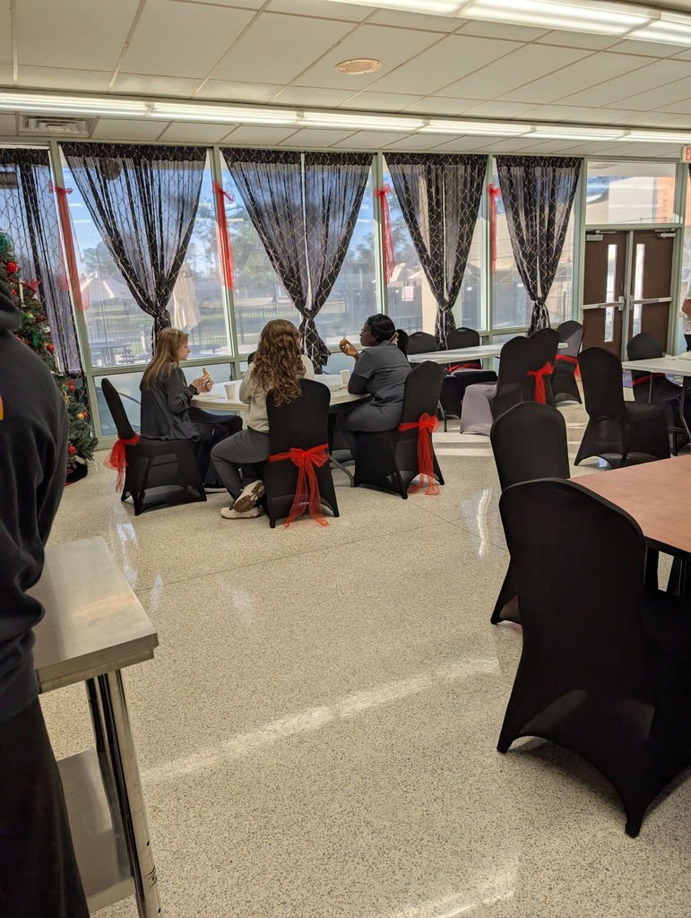 Group of students sitting down to eat breakfast