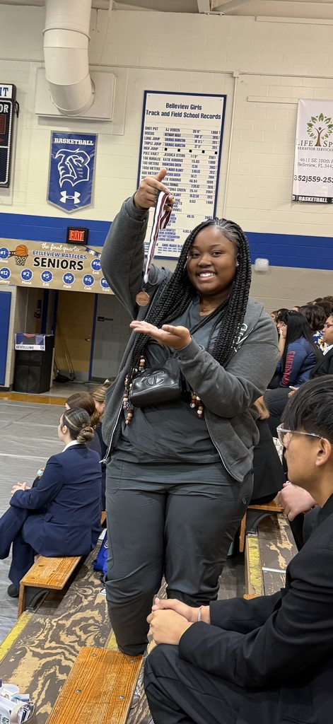 Student holding medal
