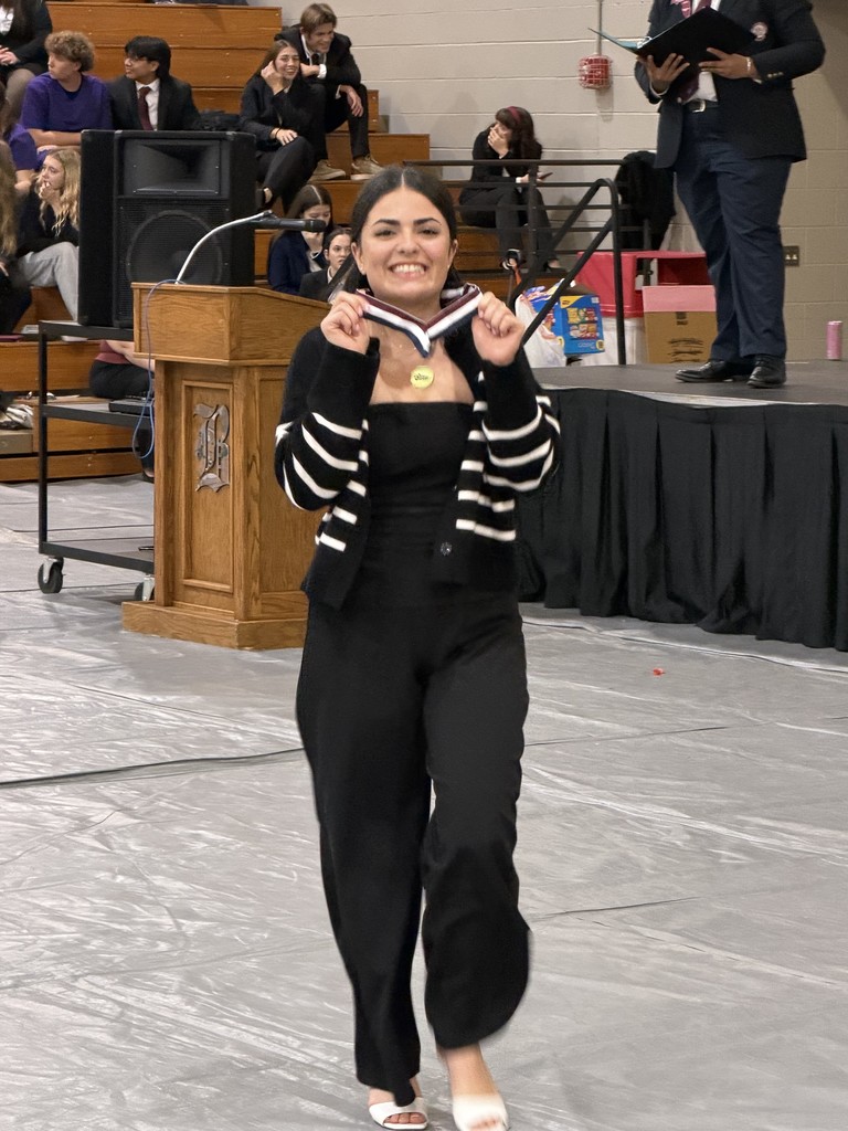 Student smiling with their medal