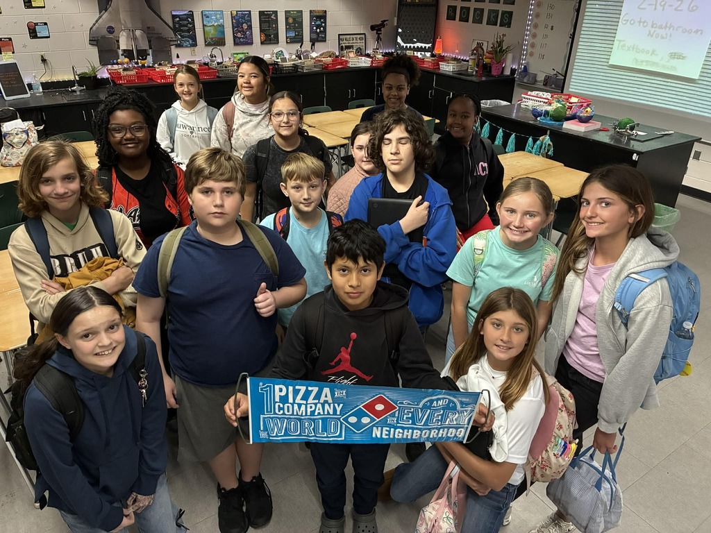 Kids holding banner for pizza