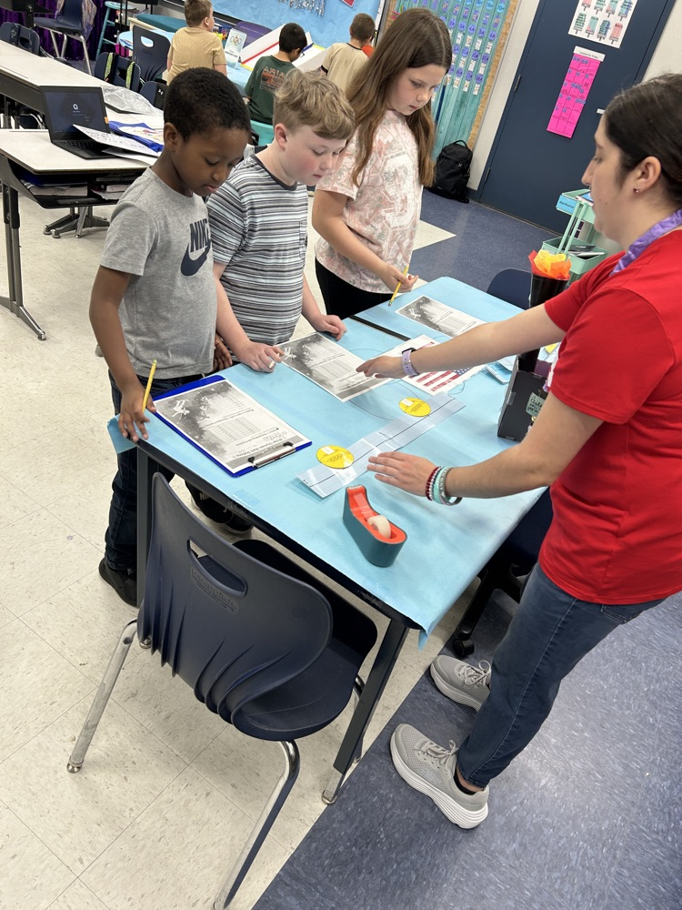 students gathered around table