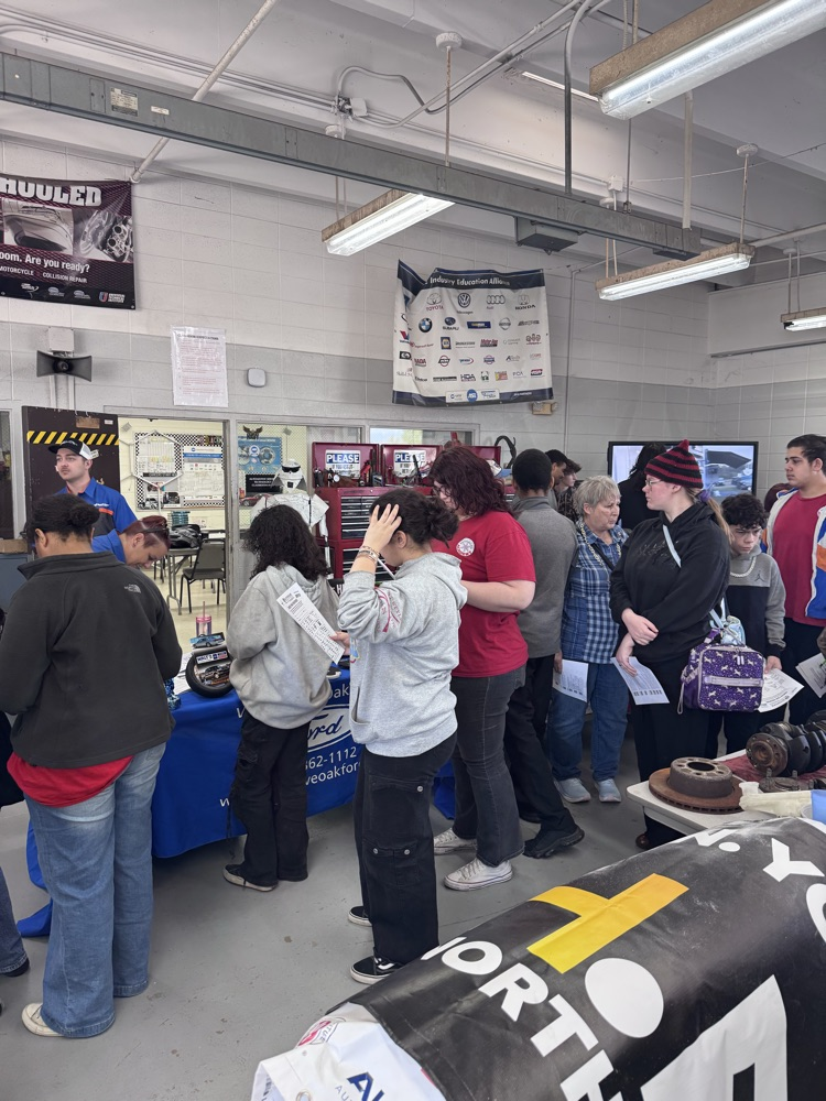 students looking at booth
