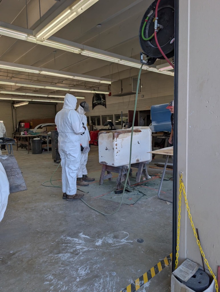 Fiberglass repair on a rusted out tub in auto collision - 7