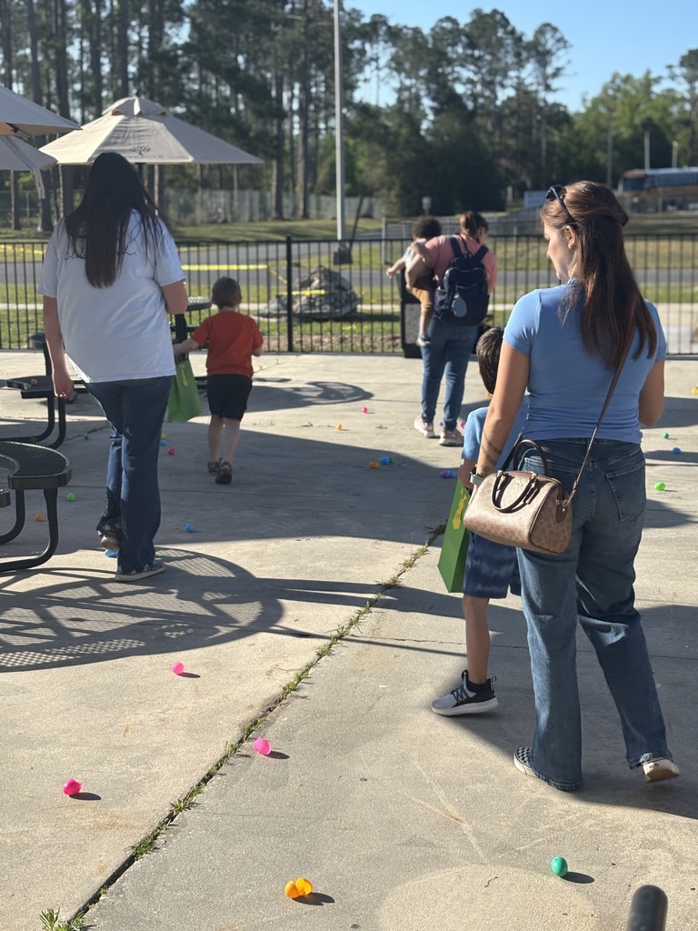 Students searching for easter eggs on patio