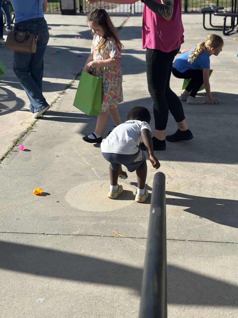 Student bending down to pick up easter egg