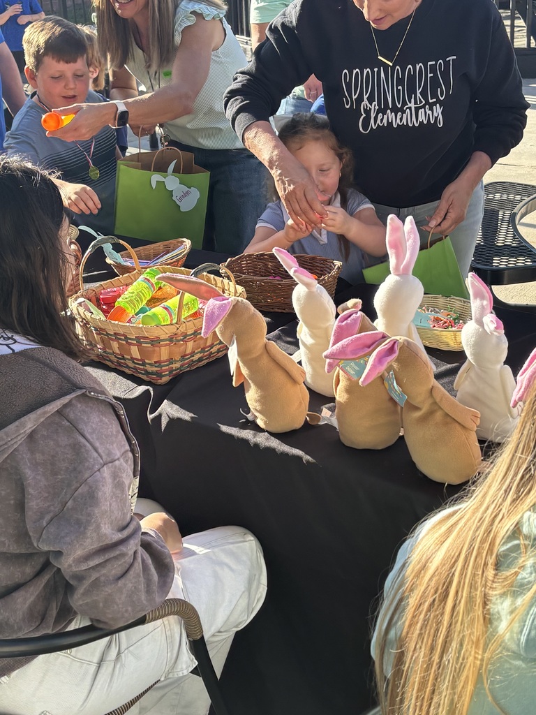 Students at table looking through easter egg baskets with bunnies on the table