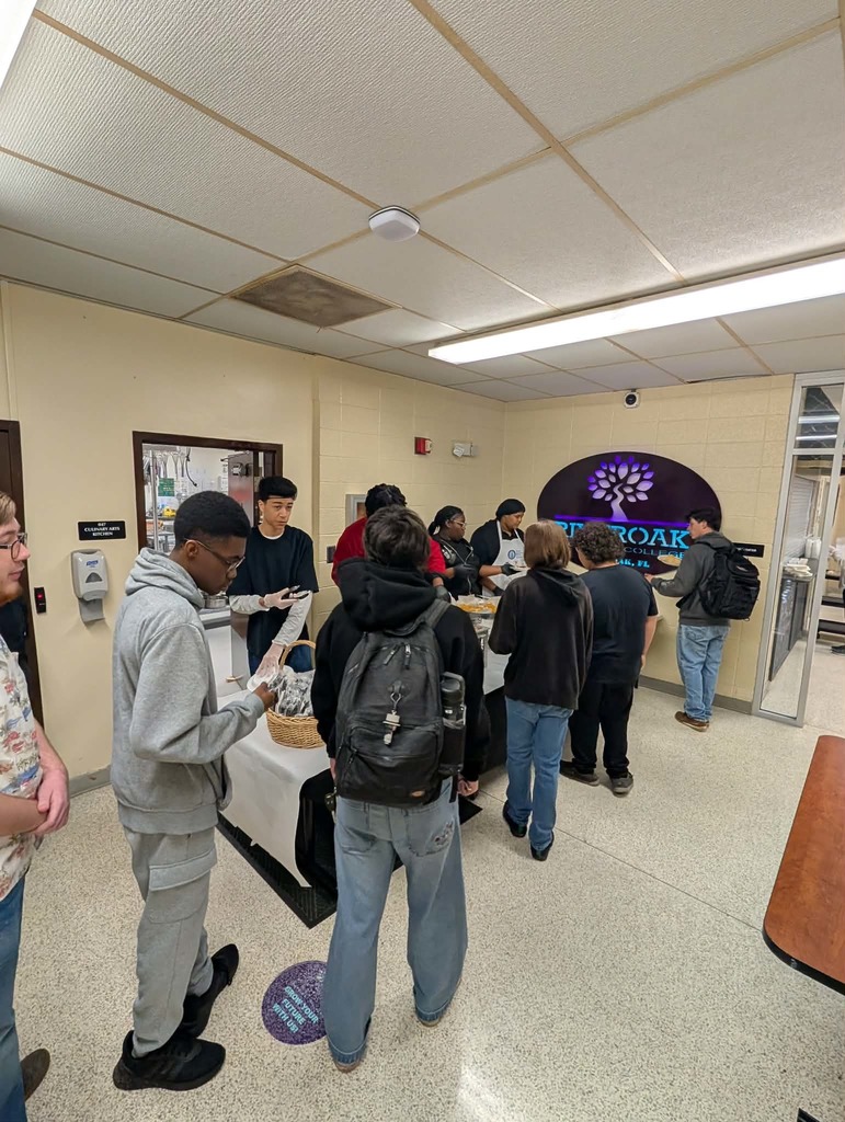 Students picking out items in breakfast line