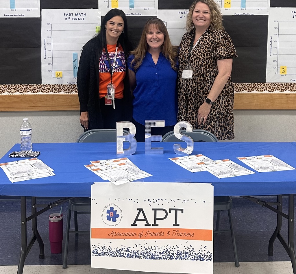BES APT members smiling at their table 
