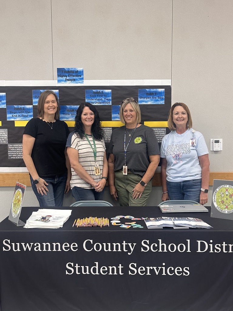 SCSD Student Services staff members smiling for a picture at their table 