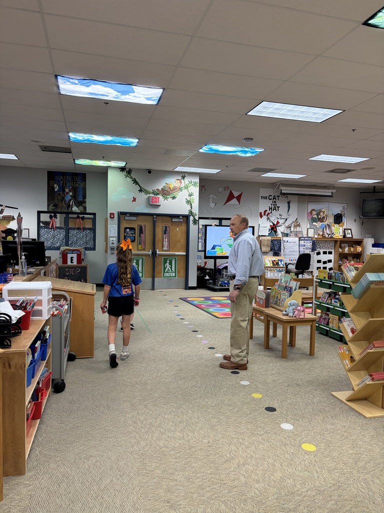 Student with Superintendent Ronnie Gray in the BES library 