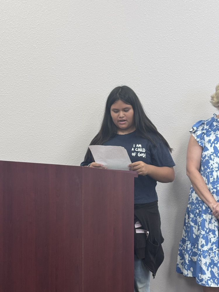 Pineview student reading in front of school board members 