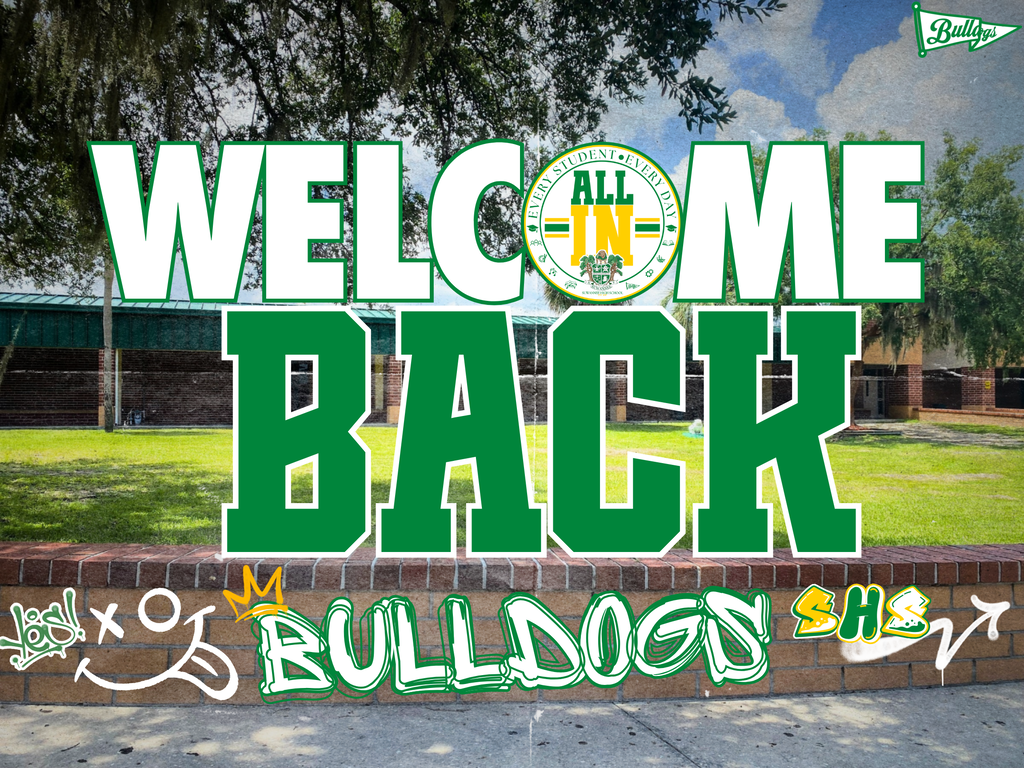 Photo of SHS Campus, with a Large Welcome Back in Green & White with Bulldogs written in grafitti on a brick wall.