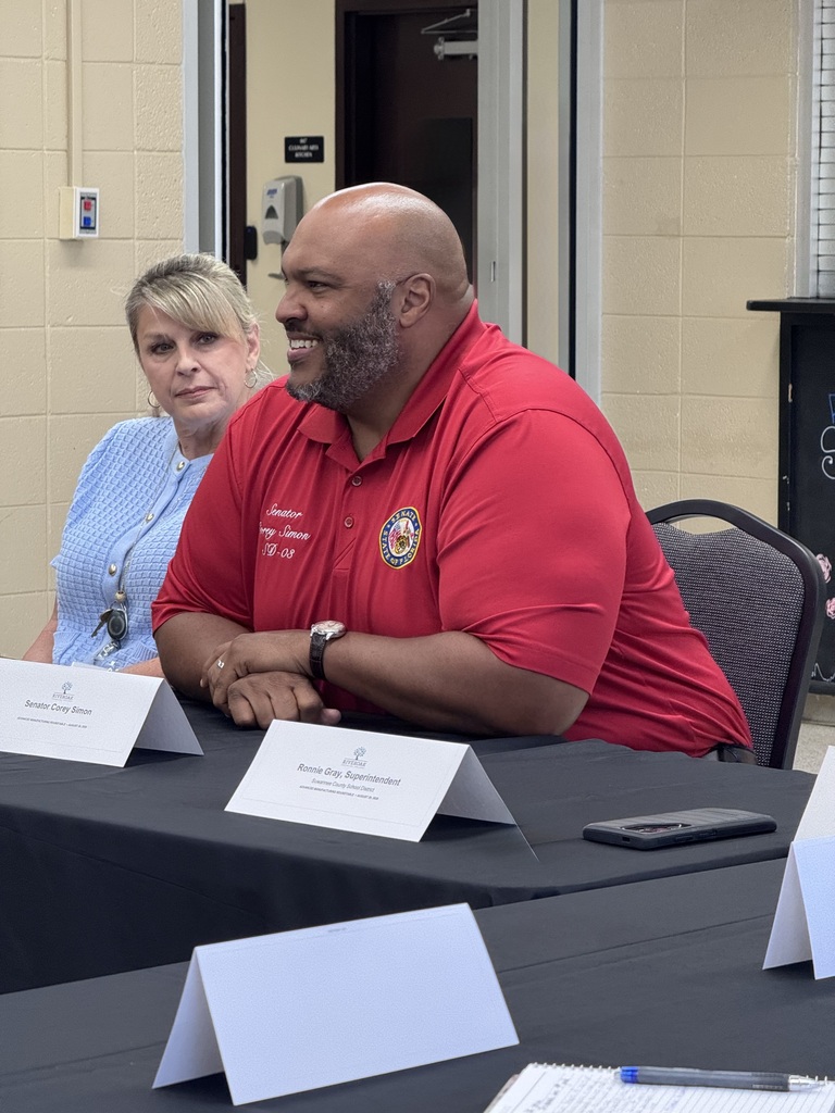 Senator Simon smiling at table next to Suwannee County School District Board Member Lesley Fry
