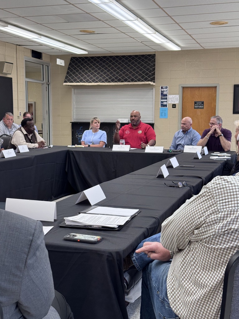 Senator Simon speaking to members at the table 