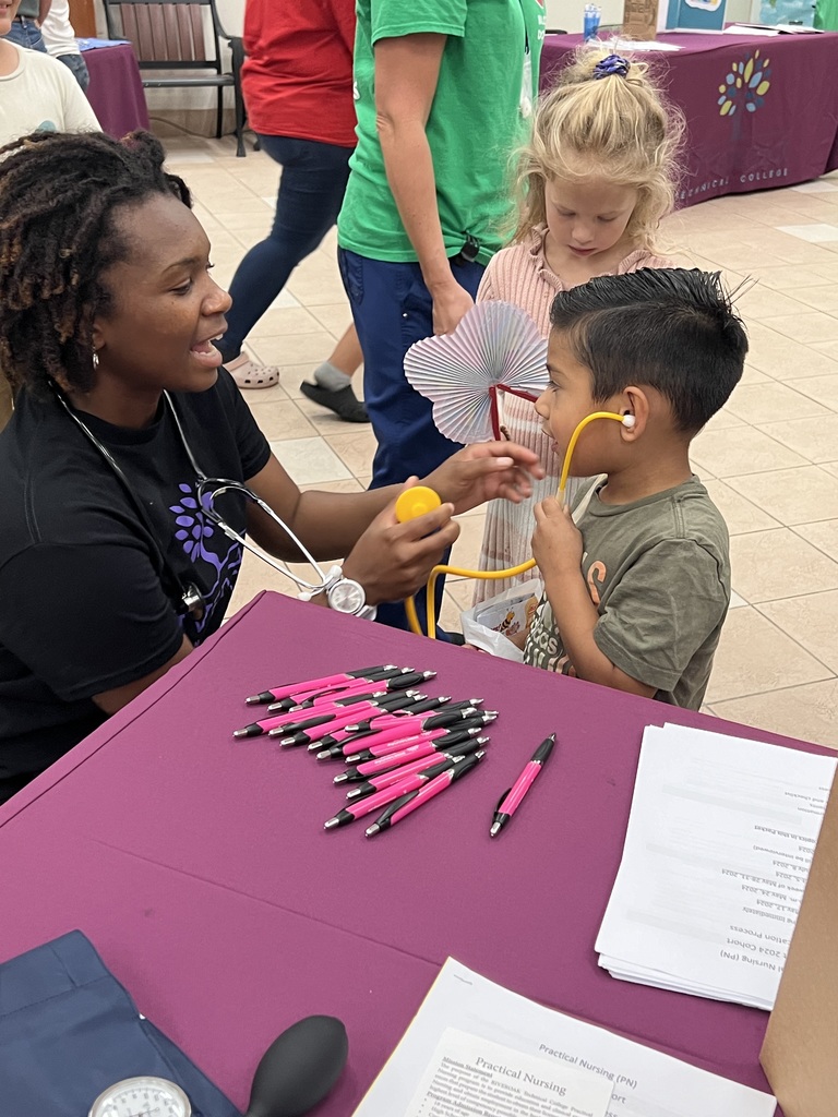 Practical Nursing student letting a young child try on stethoscope