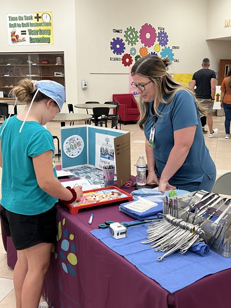 Young child interacts with Surgical Technology's booth
