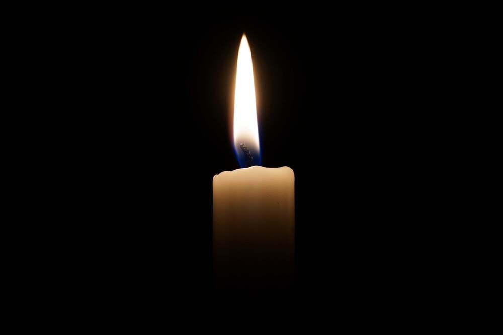 Single candle dark background