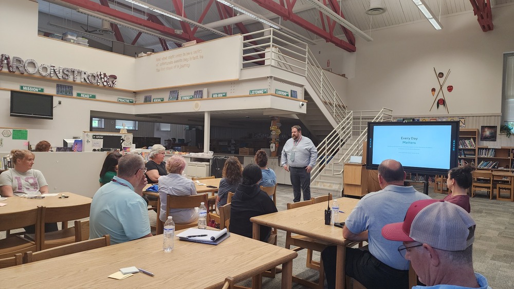 Dr. Brandon Sutton presents on Swain County Schools Absentee rates to a group of community members.