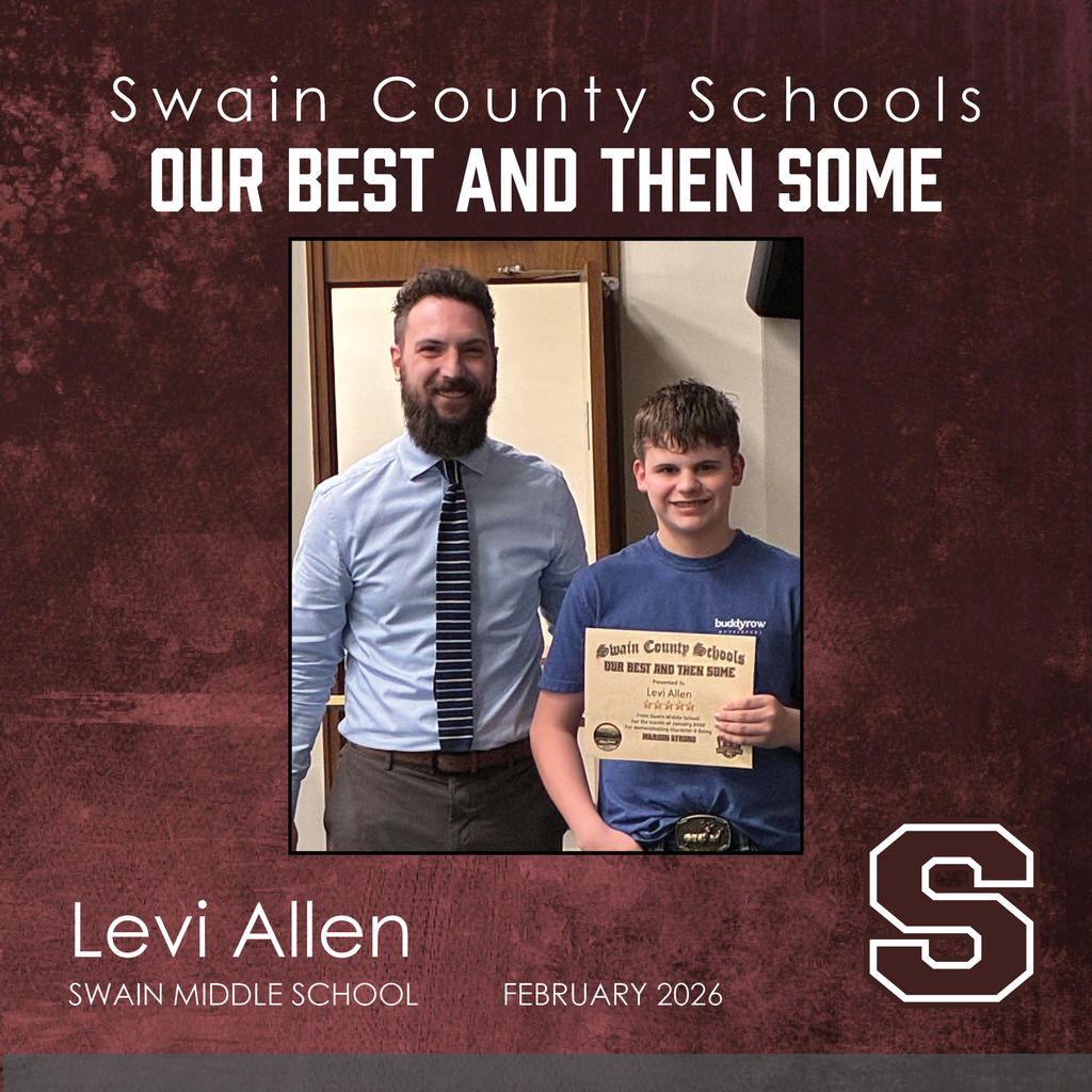 A middle-school-aged boy in a blue t-shirt smiles while holding his certificate. Standing next to him is a man with a beard, wearing a light blue button-down shirt and a striped tie.