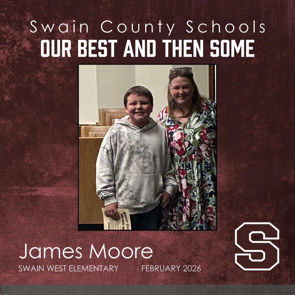 James Moore: A smiling boy in a grey acid-wash hoodie stands next to a smiling woman with blonde hair wearing a vibrant floral-print dress. He is holding his award certificate at his side.