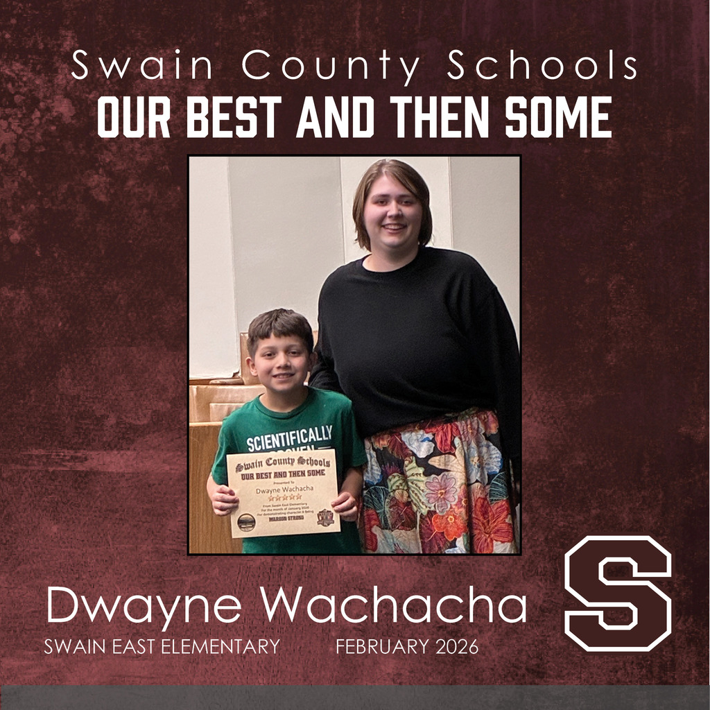 Dwayne Wachacha: A young boy in a green "Scientifically Proven" t-shirt holds his certificate. He is standing next to a smiling woman with short brown hair wearing a black long-sleeve shirt and a colorful floral skirt.