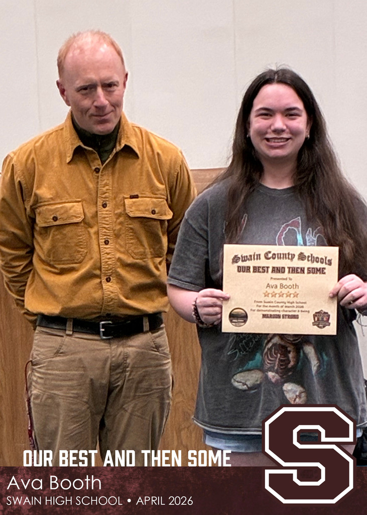 A man in a tan button-up shirt stands beside a teenage girl holding a Swain County Schools certificate recognizing her achievement.