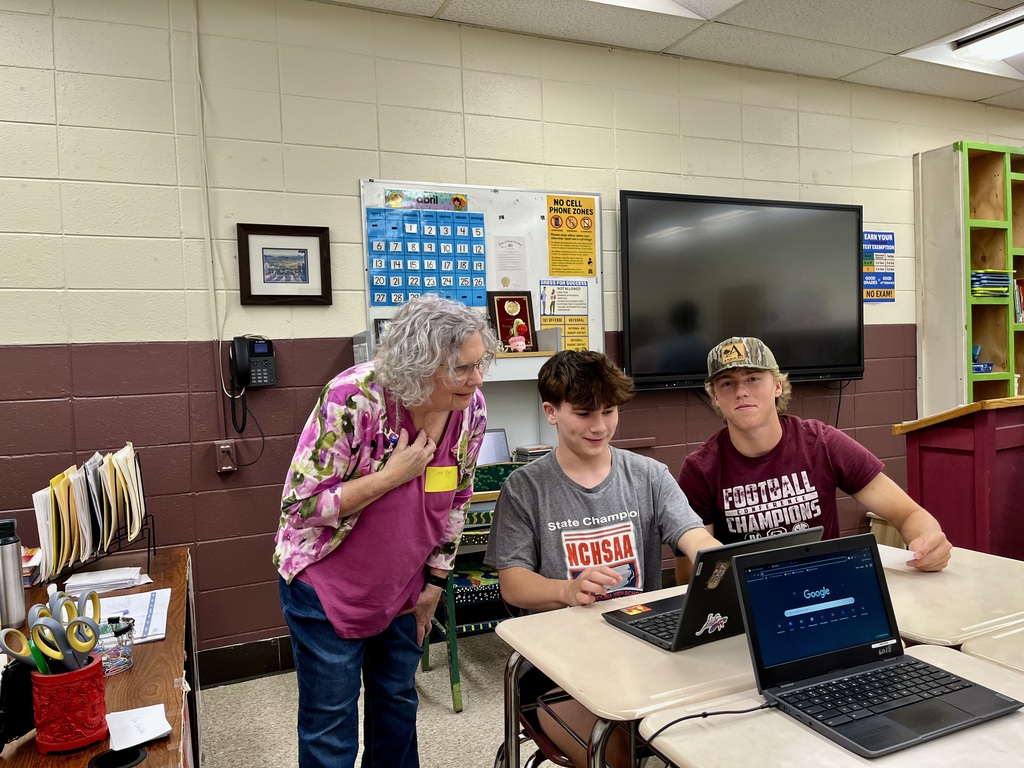 Teacher explaining paper Mache making to students