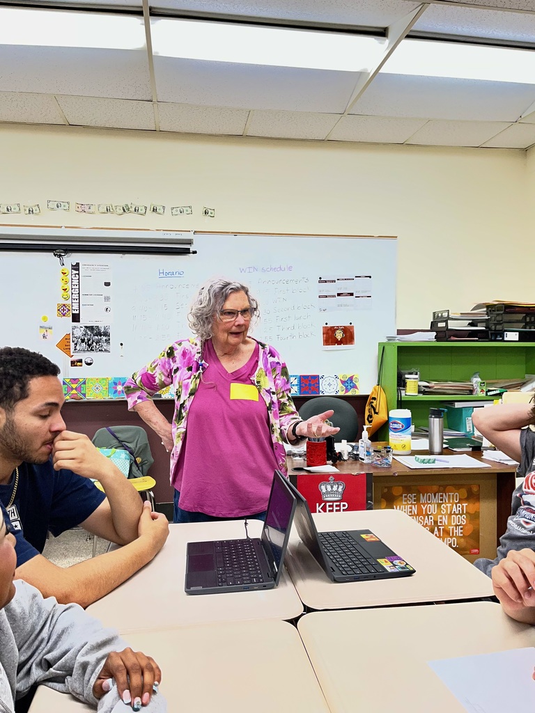 Teacher explaining paper Mache making to students