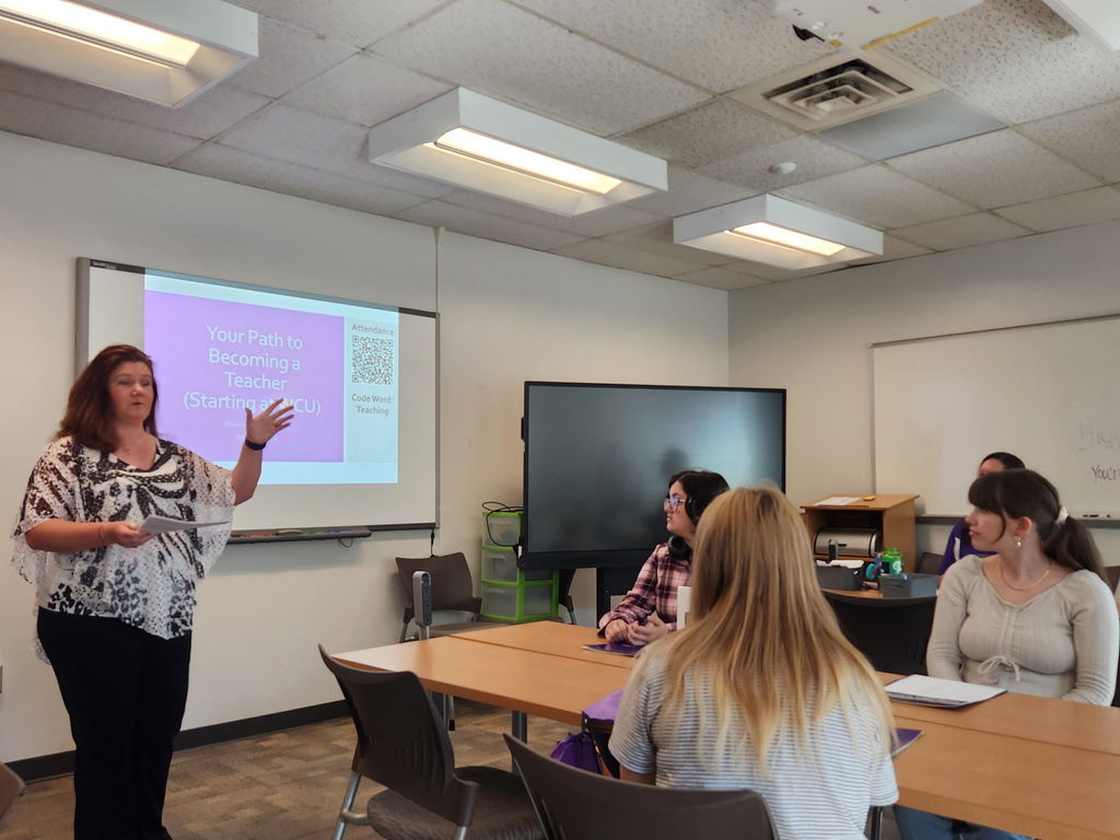 Woman speaks to students about the teaching profession.