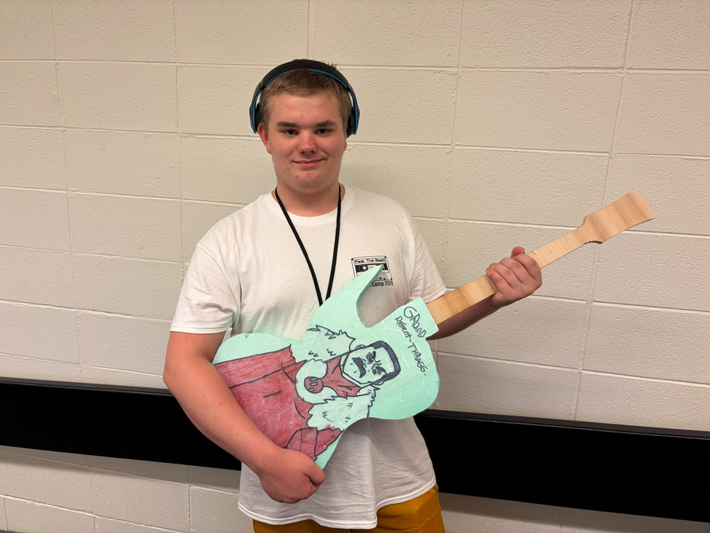 Male student holding guitar