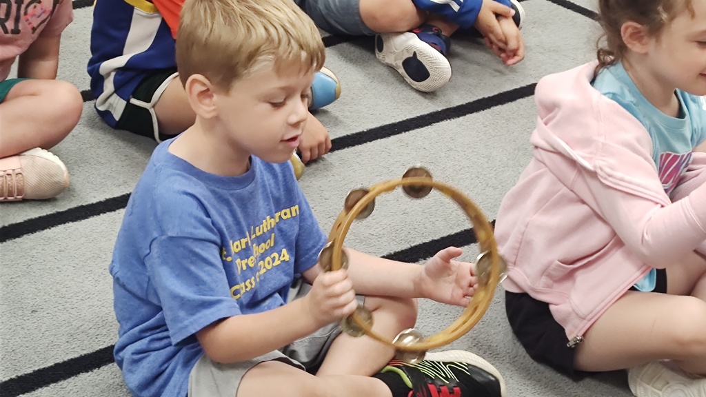 student with tambourine
