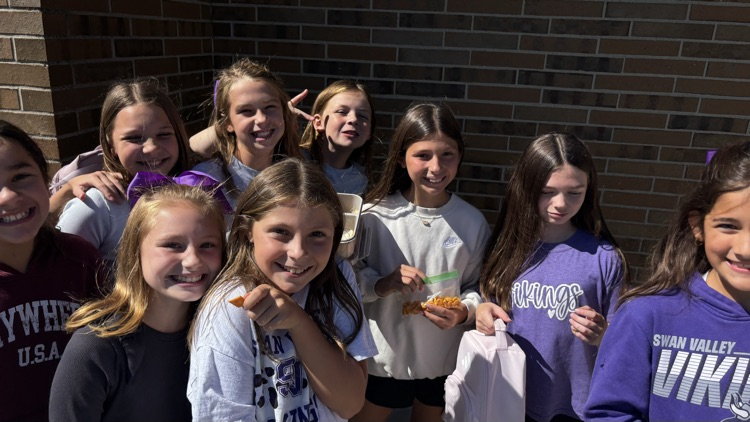 A bunch of fourth grade Vikings are eating lunch outside while enjoying the sunshine.