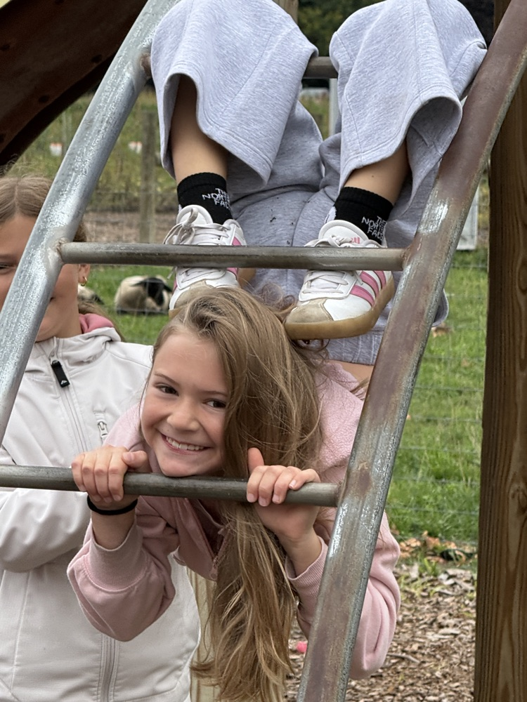 Fourth graders having fun on the monkey bars at Schomaker Farms