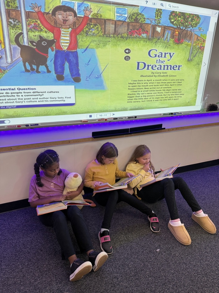 Three third graders reading together - Gary the Dreamer