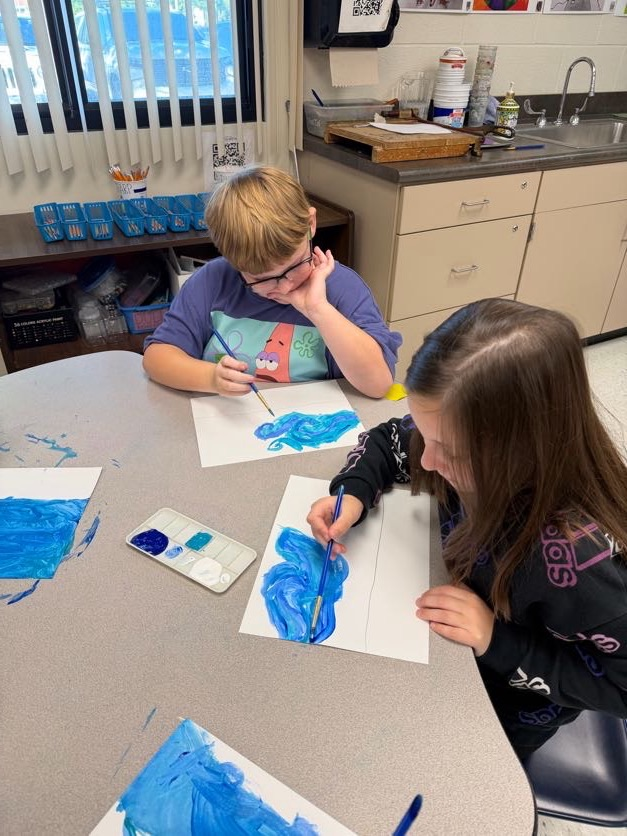 two students panting blue swirls