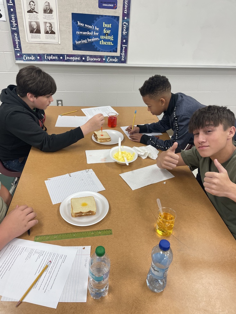 Student dropping liquid on bread.