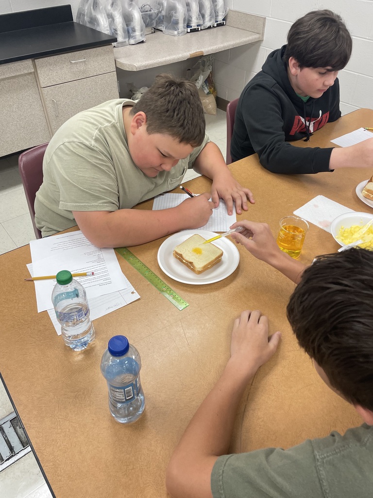Student dropping liquid on bread.