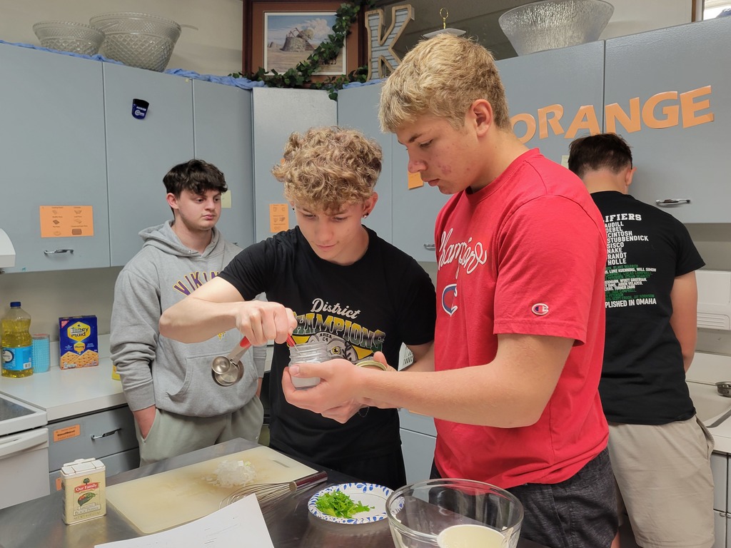 Students measure spices for their dip. 