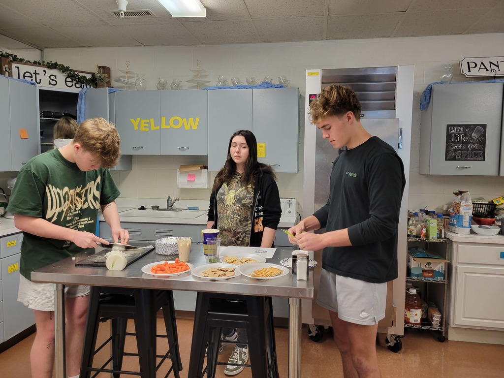 Students practice their chopping skills. 
