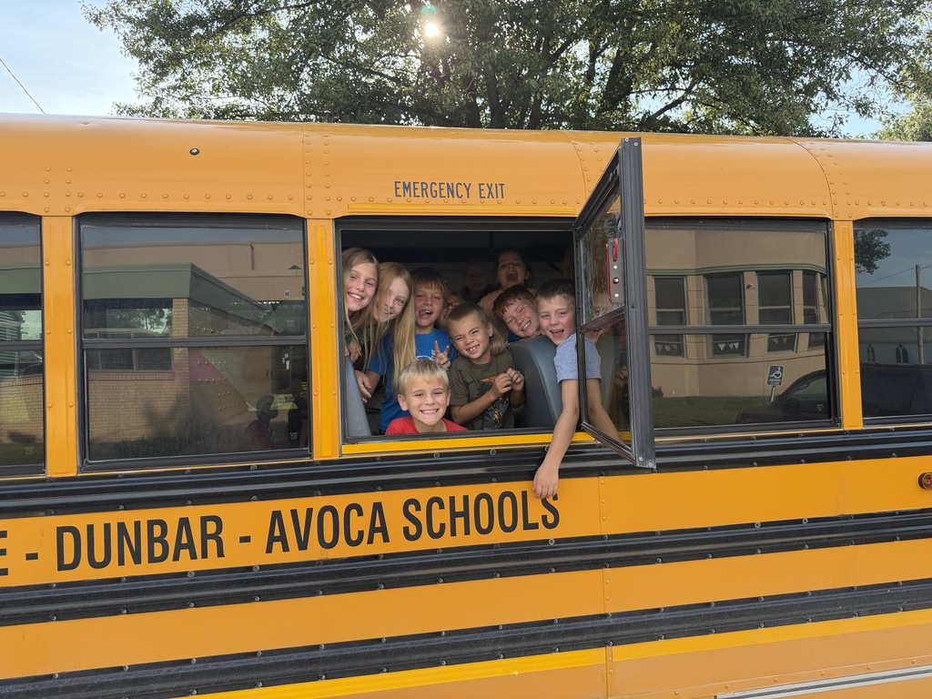 students out of bus window practicing drill