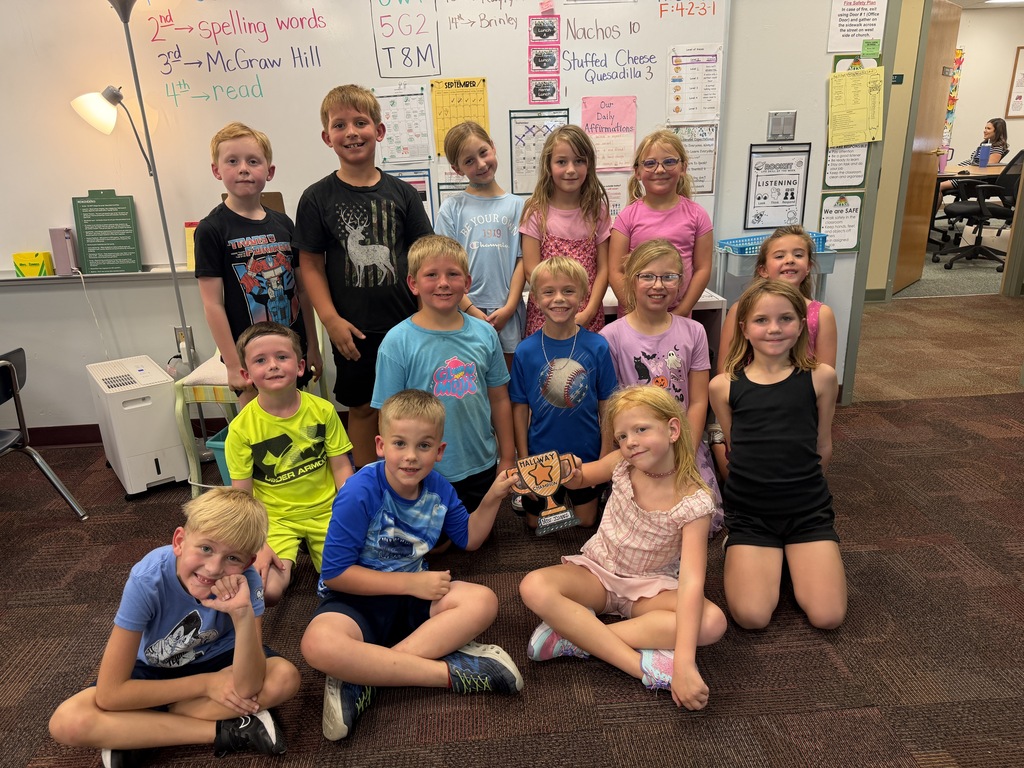 class together with their hallway champions trophy